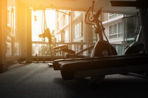 A gym with a bench and stationary bike in it