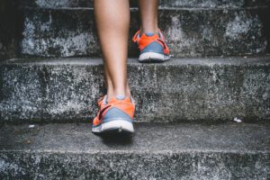 A person walking up some stairs wearing sneakers