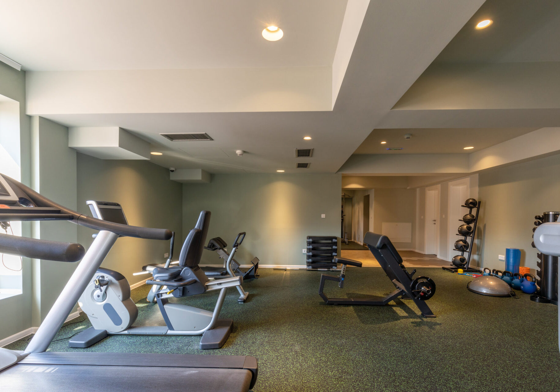 A gym with many different machines and equipment.