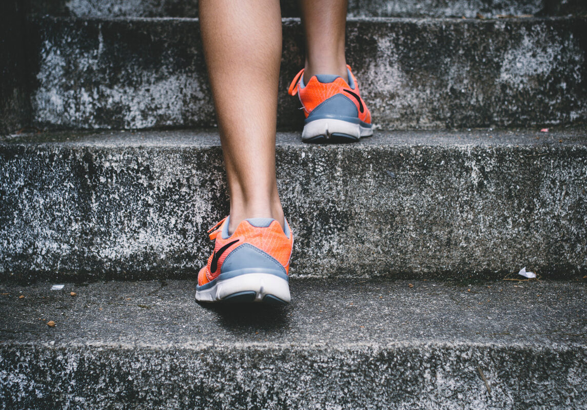 A person walking up some stairs wearing sneakers